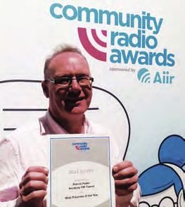 Patrick holding his Silver Award certificate at the Community Radio Awards